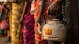 A women holds a kettle to receive salt during a monthly food distribution at the Protection of Civilian site (PoC) in Bentiu, South Sudan, on February 15, 2018.
Bentiu's Protection of Civilian site was established in January 2014, when 7,000 civilians entered the UNMISS base to seek protection, shortly after the start of the South Sudanese civil war. The camp hosts over 20,000 households and at least 114,250 individuals by IOM. the numbers keep growing every day, as fighting brings more people seeking safety.  / AFP PHOTO / Stefanie GLINSKI        (Photo credit should read STEFANIE GLINSKI/AFP/Getty Images)