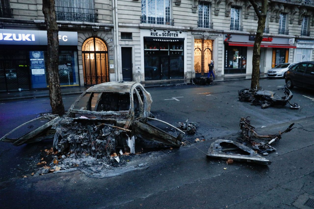 A burned car is left in the street a day after the  yellow vests demonstration against rising oil prices and living costs in Paris on December 1.