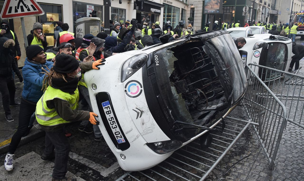 French gendarmes apprehend a protester in Paris on December 1.