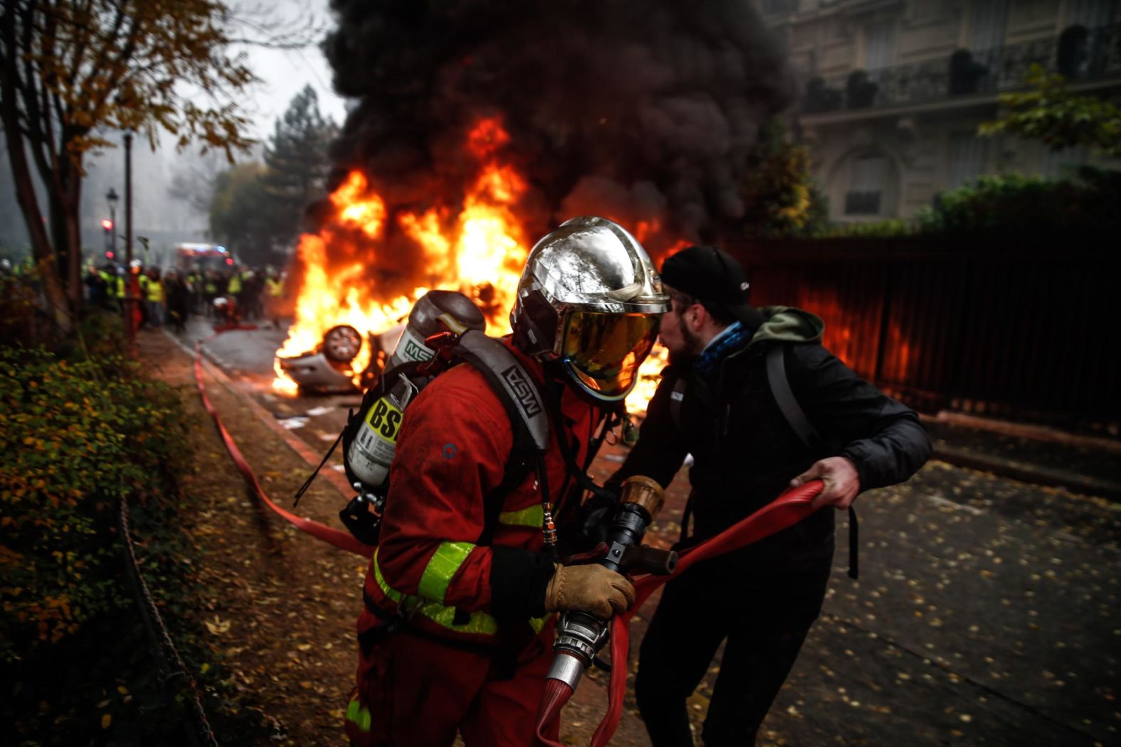 Firemen work to extinguish a burning car on December 1.