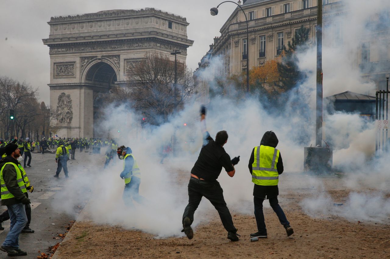 A demonstrator throws a projectile during the December 1 protest.