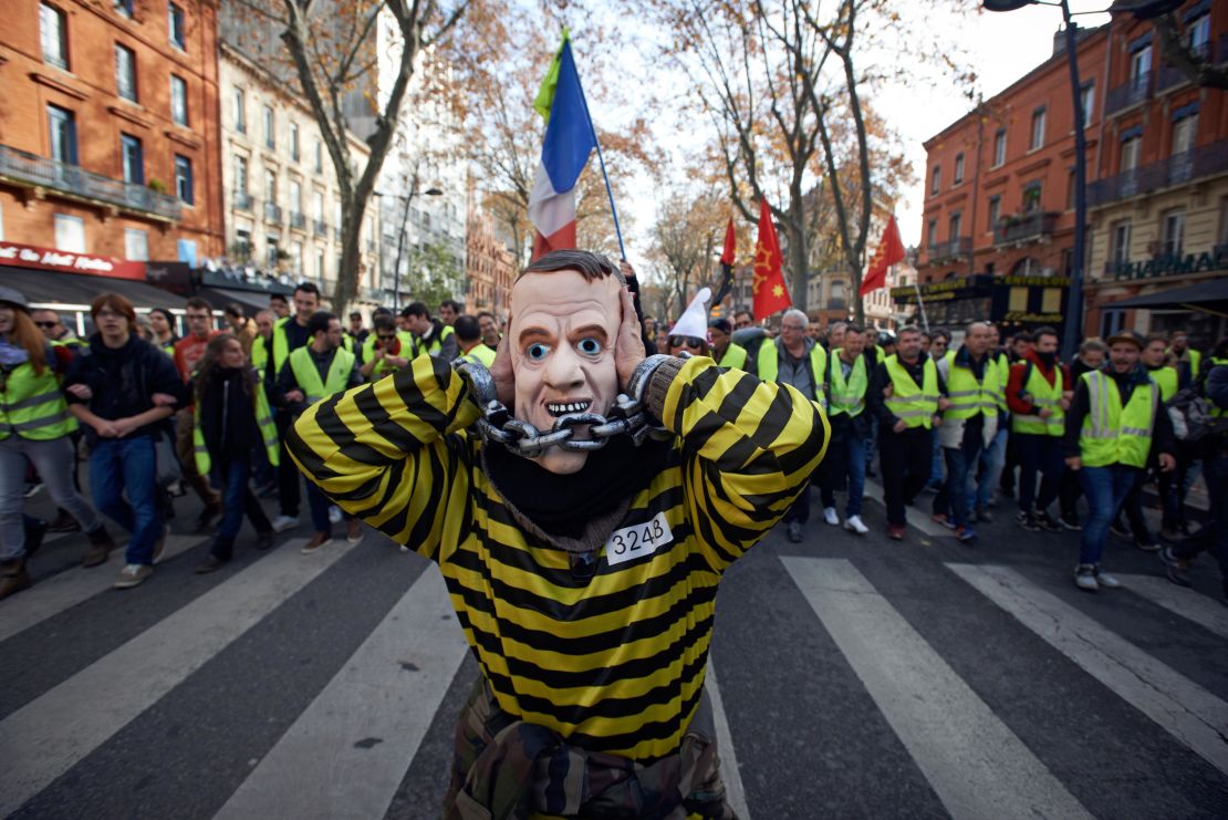 Demonstrators with the "gilets jaunes" or "yellow vest" movement call for the French President Emmanuel Macron to resign at a demonstration last month.