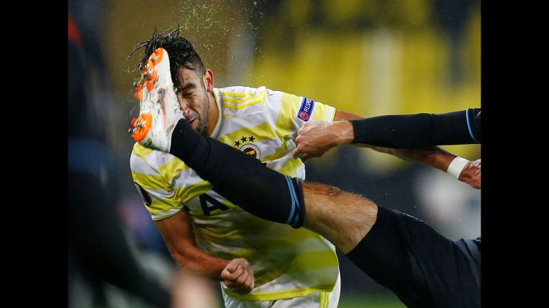 Mauricio Isla of Fenerbahce is kicked in the face during a match against GNK Dinamo Zagreb on Thursday, November 29, in Istanbul.
