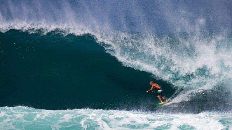 A surfer rides the Backdoor Pipeline on the North Shore of Oahu, Hawaii, on Wednesday, November 28.