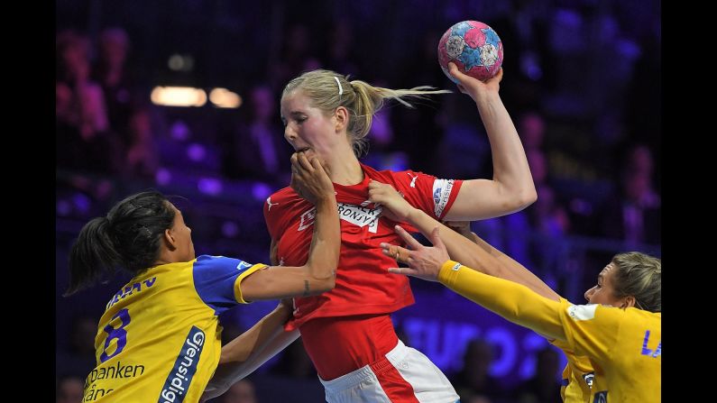 Denmark's Mette Tranborg is swarmed by Sweden players during a preliminary match between Denmark and Sweden at the European Women's Handball Championships on Friday, November 30, in Nantes, France.