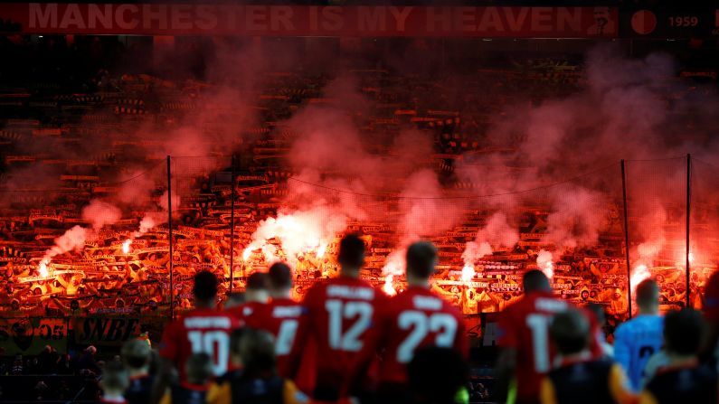 Fans set off flares as players walk out before a match between Manchester United and BSC Young Boys on Tuesday, November 27, in Manchester, England.