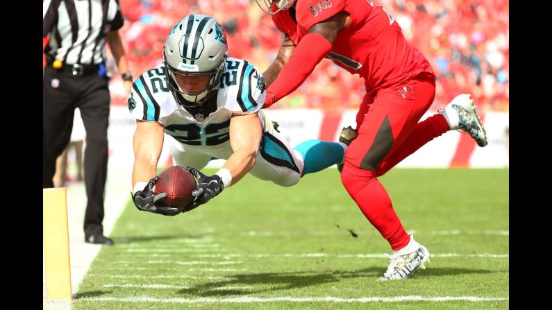 Christian McCaffrey of the Carolina Panthers scores a touchdown on an 8-yard pass from Cam Newton during the first quarter against the Tampa Bay Buccaneers at Raymond James Stadium on Sunday, December 2, in Tampa, Florida. The Panthers lost the game 17-24.