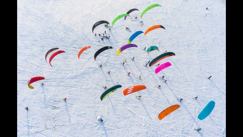 Participants compete in the 2018 Siberian Snowkiting Cup on the frozen Novosibirsk Reservoir near the Novosibirsk hydroelectric power plant in Novosibirsk, Russia, on Wednesday, November 28.