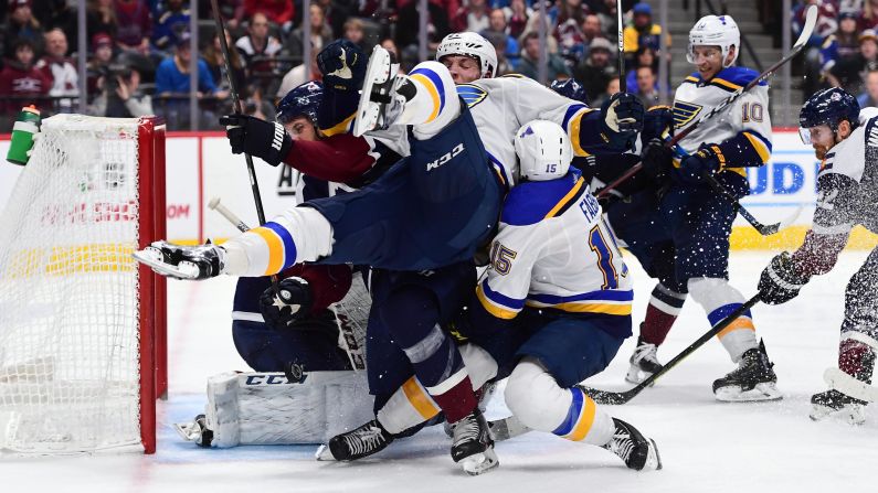 St. Louis Blues left wing David Perron crashes into Blues center Robby Fabbri and defenseman Patrik Nemeth during the third period of a Friday, November 30, game at the Pepsi Center in Denver.