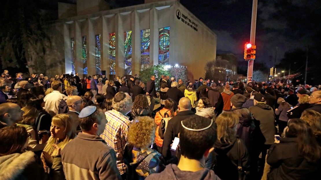 A crowd gathers outside the Tree of Life Synagogue on Sunday, the first night of Hanukkah.