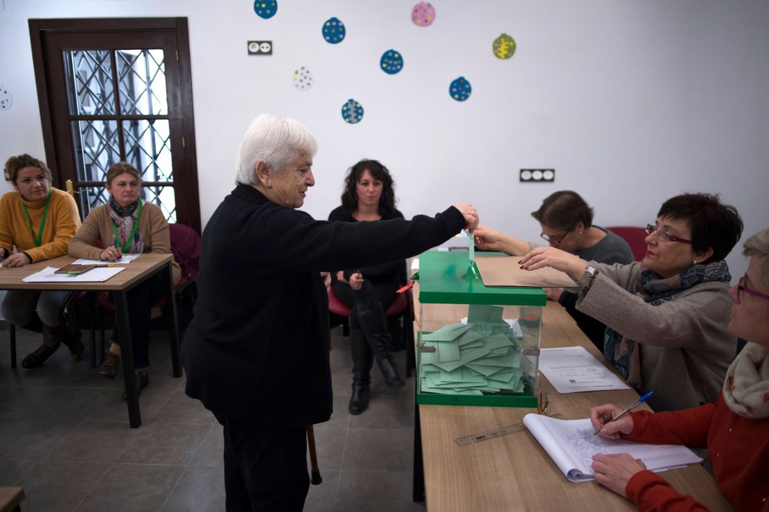 A woman casts her vote at a polling station in Carratraca near Malaga on December 2, 2018 during Andalusia's regional election. 