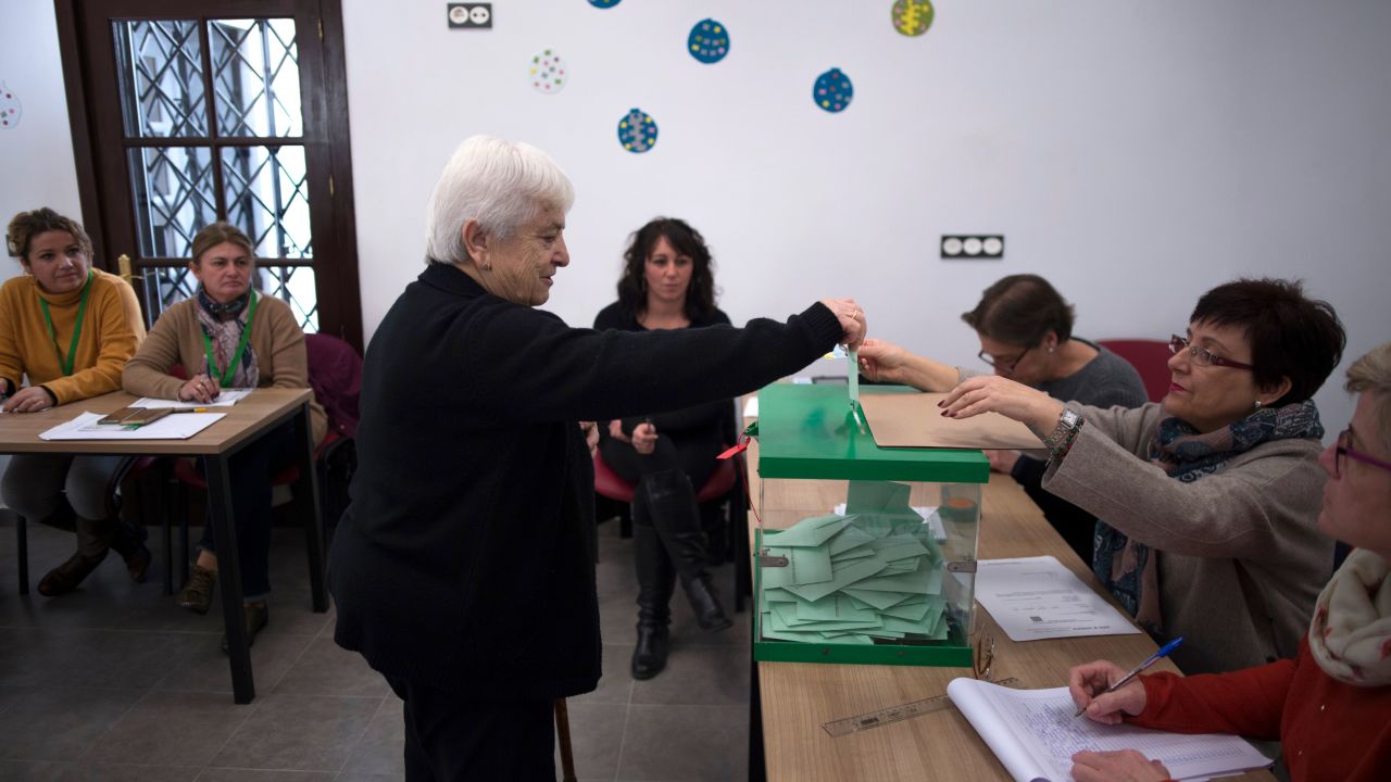 A woman casts her vote at a polling station in Carratraca near Malaga on December 2, 2018 during Andalusia's regional election. 
