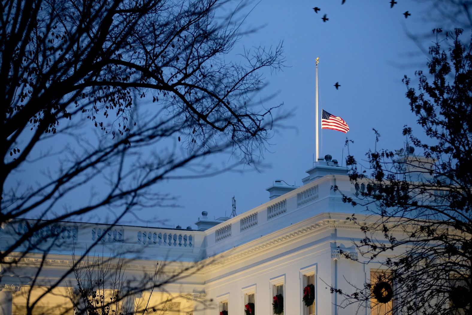 The flag flies at half-staff at the White House on December 1.