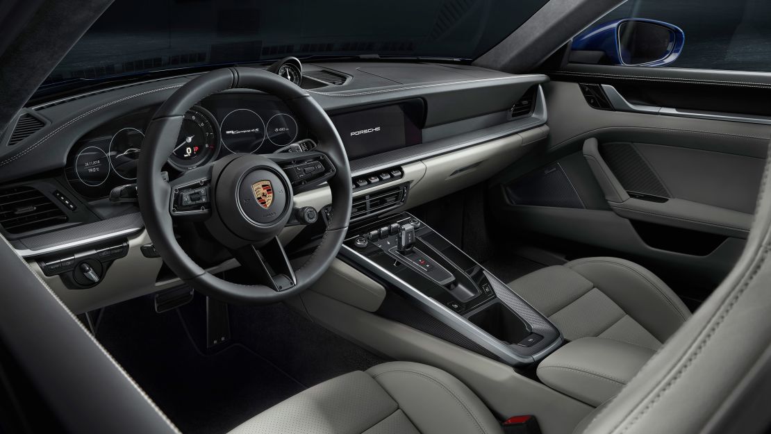 The new Porsche 911's interior has a cleaner look thanks to touch screens replacing many of the knobs and switches.