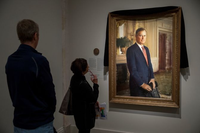 People look at Bush's official portrait, which was draped in black cloth at the National Portrait Gallery in Washington.