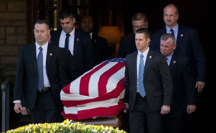 Pallbearers carry Bush's casket out of the Houston funeral home.