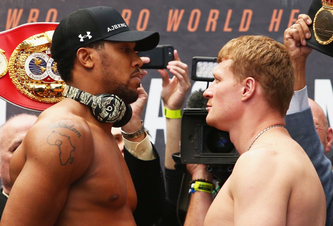 Anthony Joshua (left) has an outline of Africa on his right shoulder. 