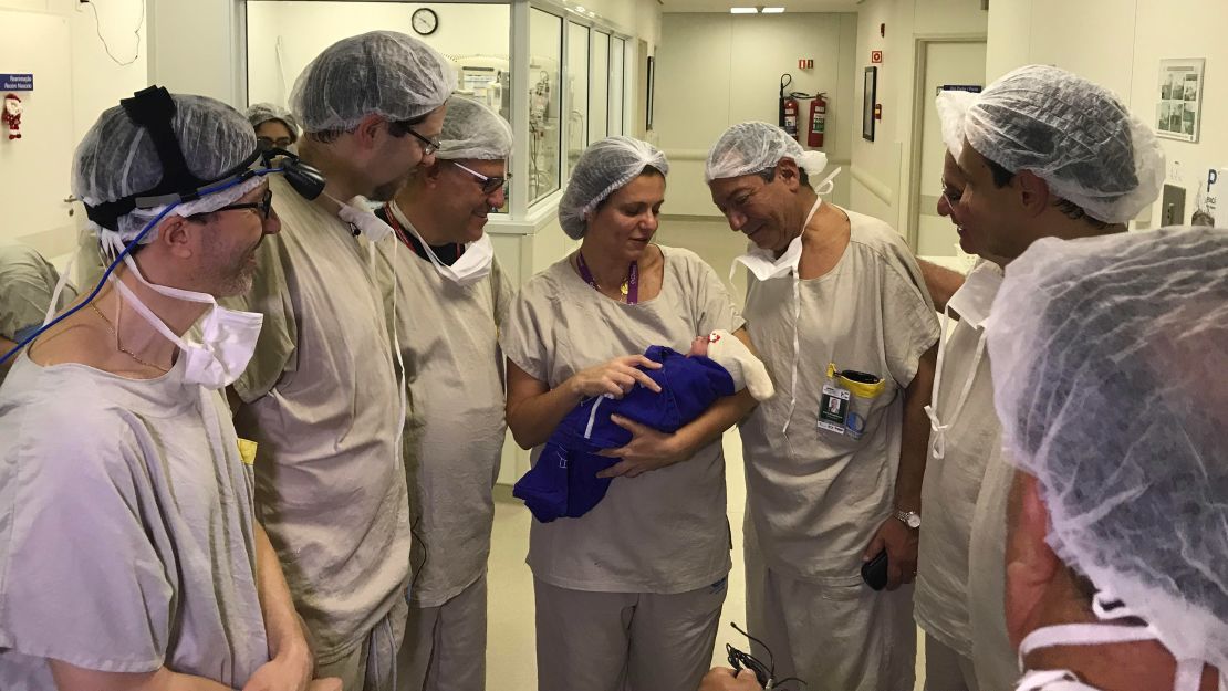 Members of the transplant and embryo transfer teams with the newborn.