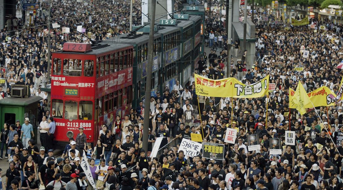 Trams sit stranded as hundreds of thousands of people block the streets in a huge protest march against a controversial anti-subversion law known as Article 23 in Hong Kong in 2003. 