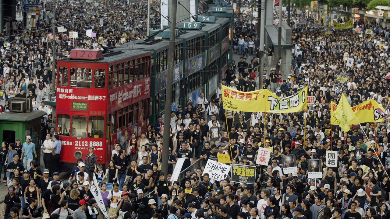 Trams sit stranded as hundreds of thousands of people block the streets in a huge protest march against a controversial anti-subversion law known as Article 23 in Hong Kong in 2003. 