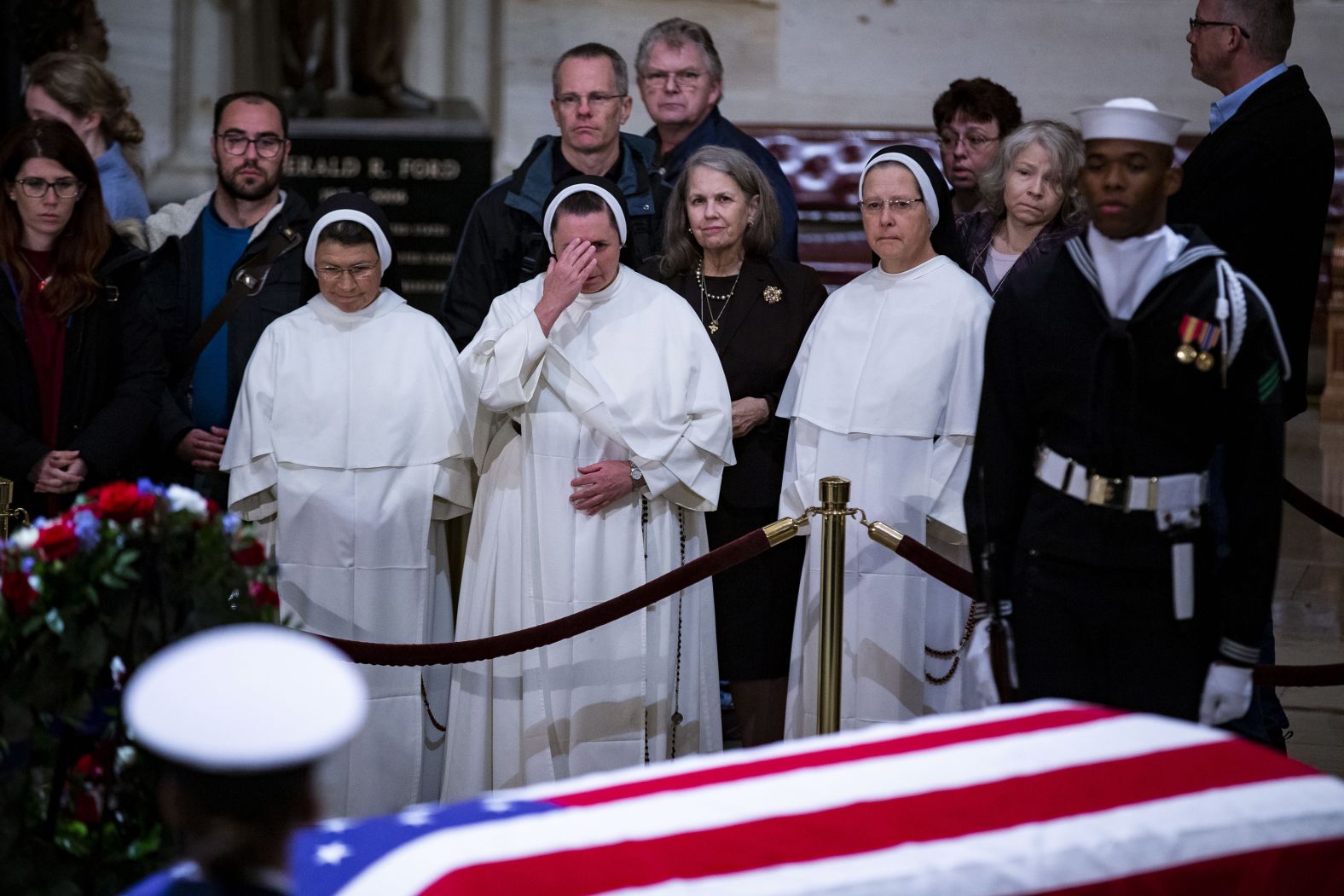 Members of the public pay their respects to the late President on December 3.