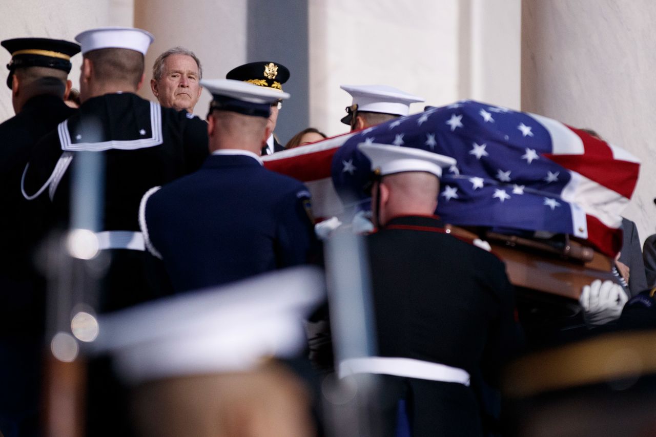 Former President George W. Bush watches his father's casket arrive at the Capitol on December 3.