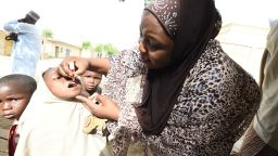 UNICEF health consultant Hadiza Waya (R) tries to immunise a child during vaccination campaign against polio at Hotoro-Kudu, Nassarawa district of Kano in northwest Nigeria, on April 22, 2017.
The World Health Organization said116 million children are to receive polio vaccines in 13 countries in west and central Africa as part of efforts to eradicate the disease on the continent. "The synchronised vaccination campaign, one of the largest of its kind ever implemented in Africa, is part of urgent measures to permanently stop polio on the continent," the WHO said.  / AFP PHOTO / PIUS UTOMI EKPEI        (Photo credit should read PIUS UTOMI EKPEI/AFP/Getty Images)