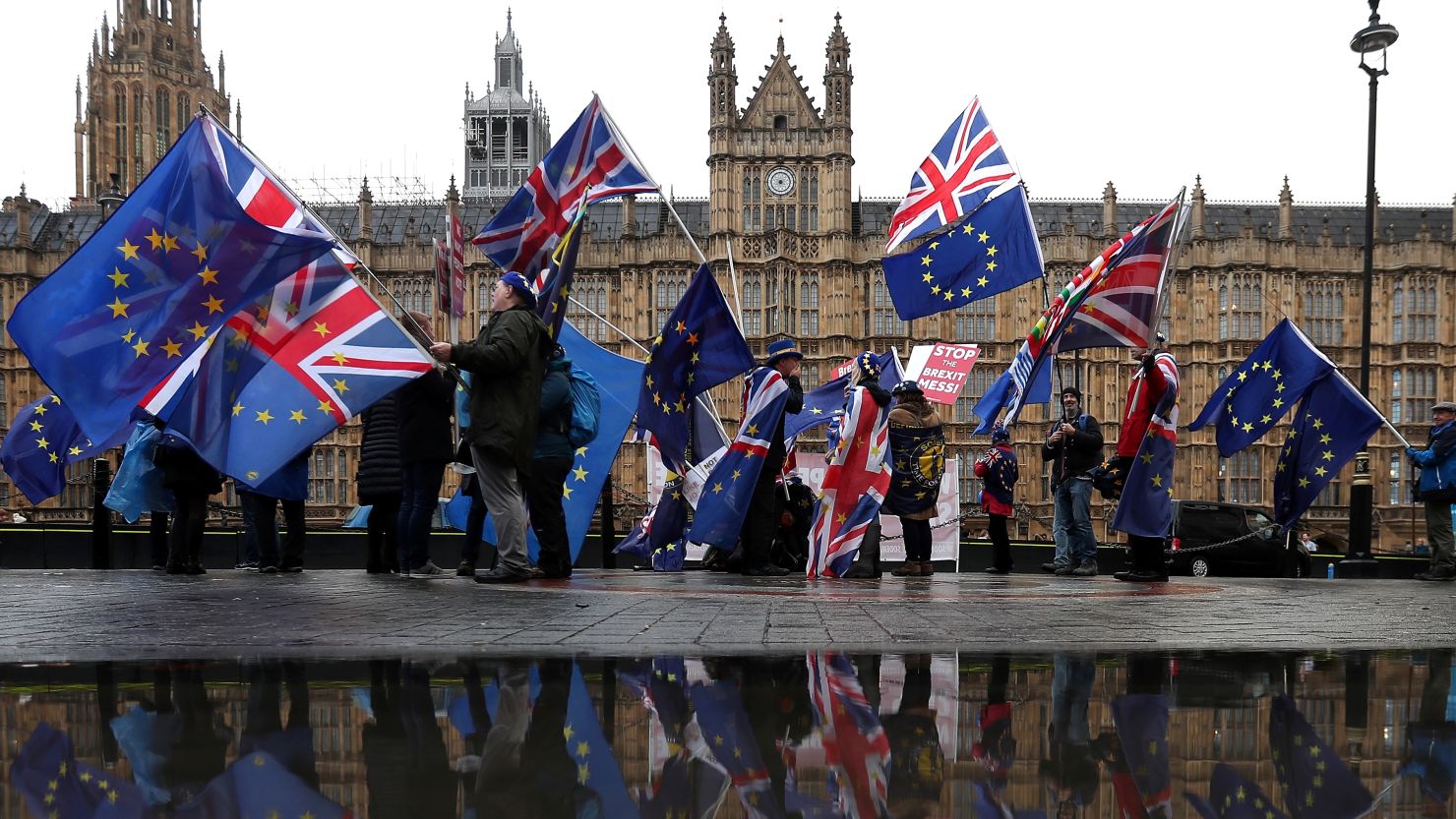 Anti-Brexit protesters wave EU flags outside Parliament.