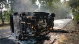 An upturned and smouldering vehicle is seen following mob violence at Chingravati village in Bulandhahr, India's northern Uttar Pradesh state, on December 3, 2018. - A violent mob rampaged through villages in northern India on December 3 after the discovery of suspected cow carcasses, setting vehicles ablaze and murdering two people including a senior police officer. (Photo by - / AFP)        (Photo credit should read -/AFP/Getty Images)