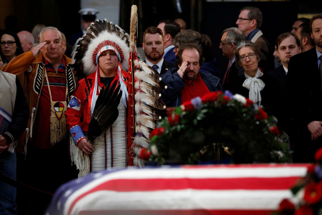 Warren Stade, left, and Donald Woody, second left, say goodbye to Bush on December 4. They are Native Americans of the Shakopee Mdewakanton Sioux Community tribe in Prior Lake, Minnesota.