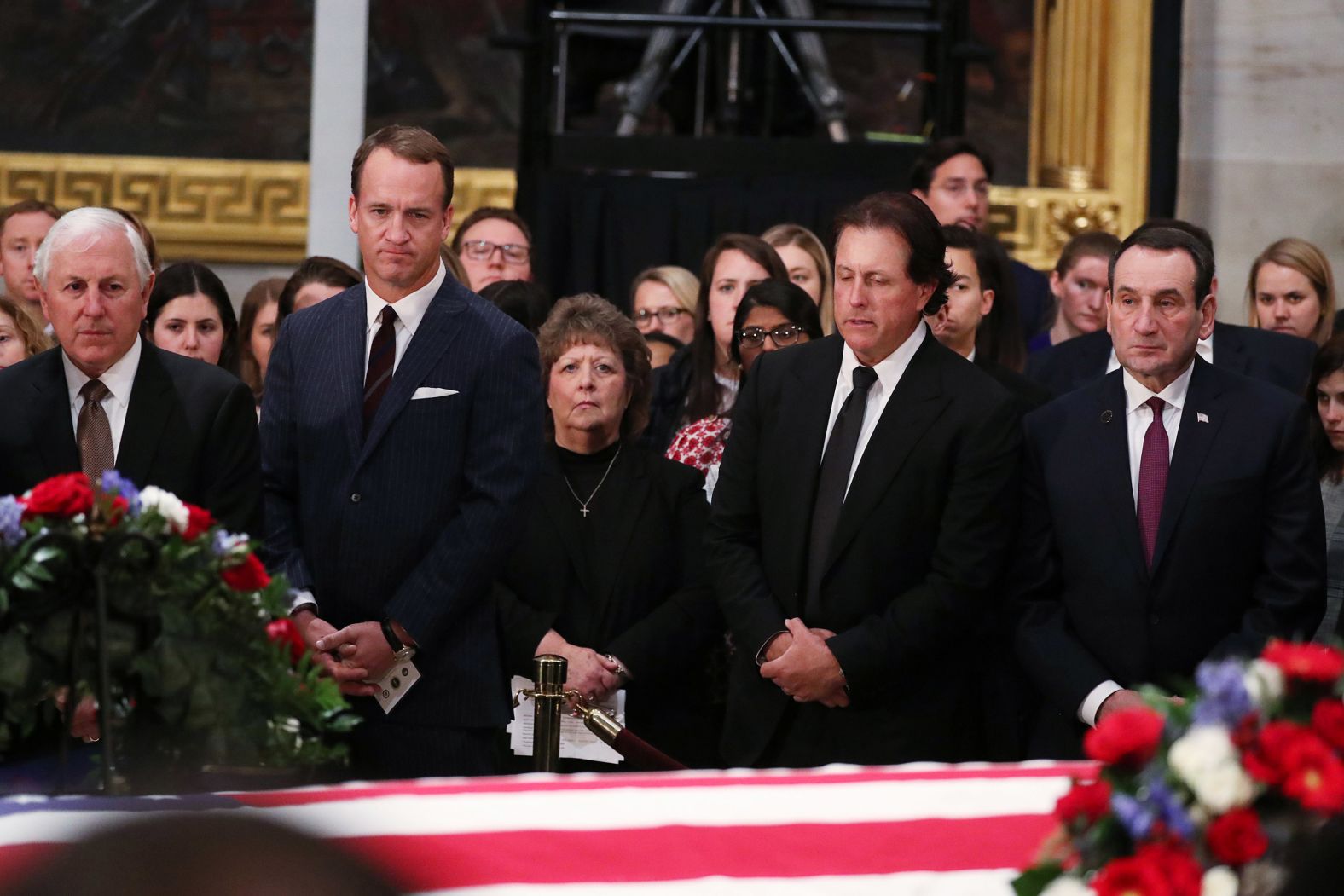 From left, retired golfer Hale Irwin, former NFL quarterback Peyton Manning, golfer Phil Mickelson and Duke basketball coach Mike Krzyzewski pay their respects on December 4.