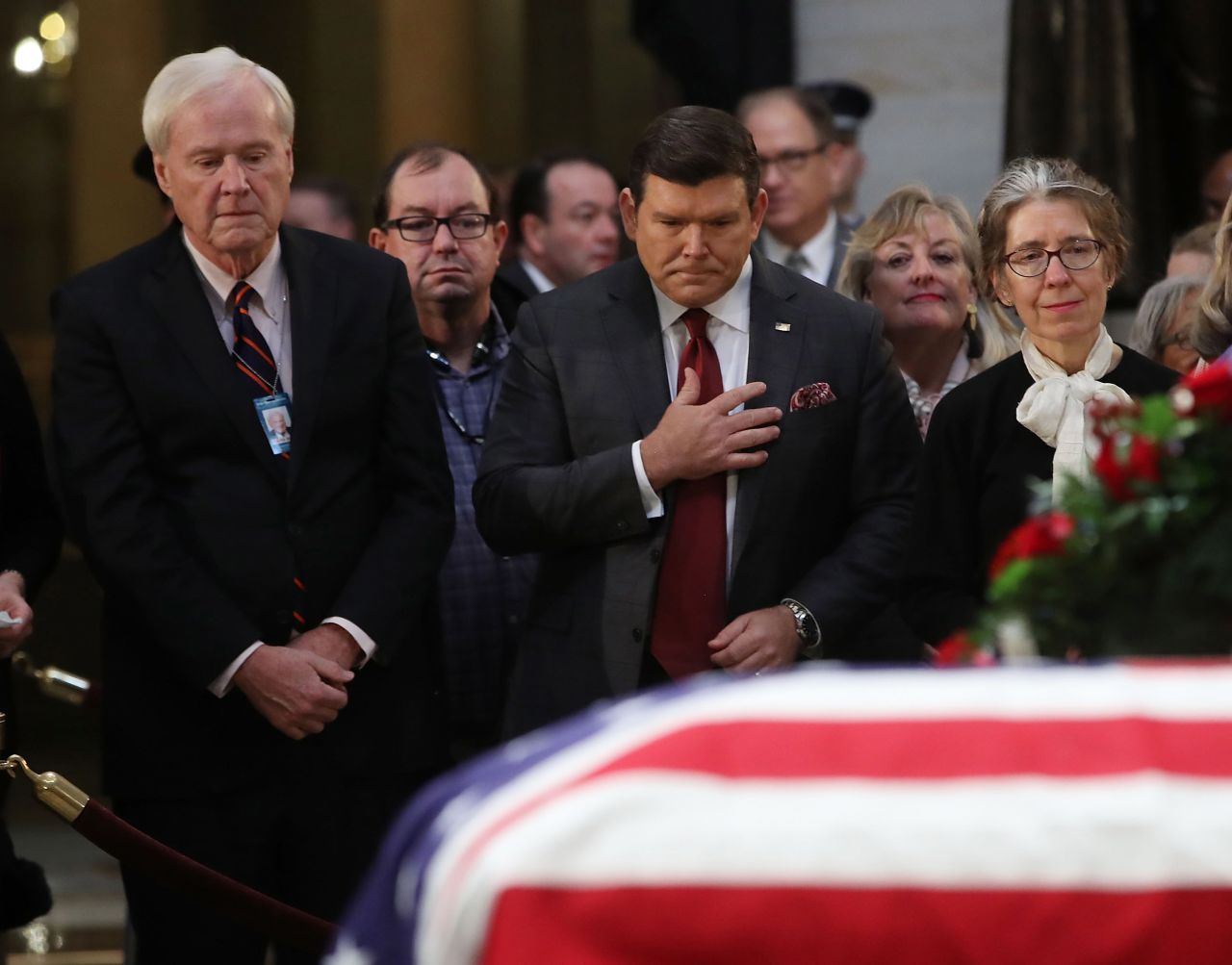 MSNBC television anchor Chris Matthews, left, and Fox News anchor Bret Baier visit Bush's casket.