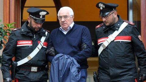Settimino Mineo, jeweller and new head of the Sicilian mafia, is escorted by carabinieri as he leaves a police station following his arrest this week.
