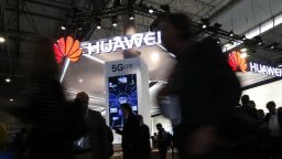 People walk by the Huawei stand at the Mobile World Congress in Barcelona.