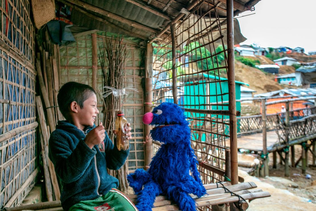 The always lovable Grover plays with a boy at a Rohingya refugee camp in Cox's Bazar, Bangladesh.