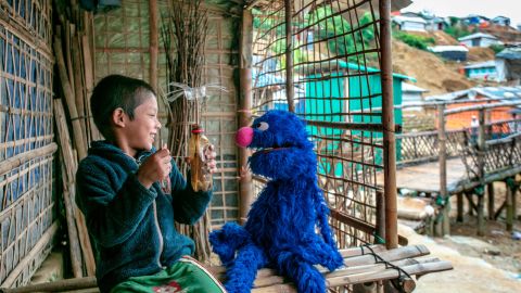 The always lovable Grover plays with a boy at a Rohingya refugee camp in Cox's Bazar, Bangladesh. 