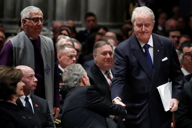 Former Canadian Prime Minister Brian Mulroney, right, shakes hands with George W. Bush during the state funeral on December 5.