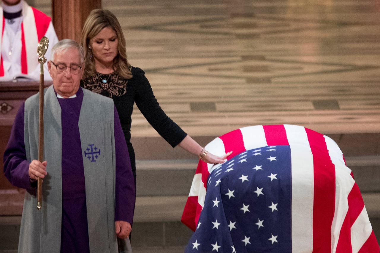 Jenna Bush Hager, one of the late President's granddaughters, touches his casket at the funeral.