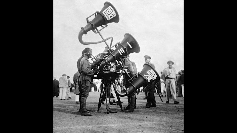 Japanese soldiers demonstrate the use of a "war tuba." 