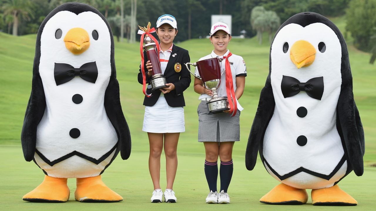 <strong>Penguin suits:</strong> Golfers Yuka Yasuda and Kotono Kozuma pose with two mascots on a golf course.