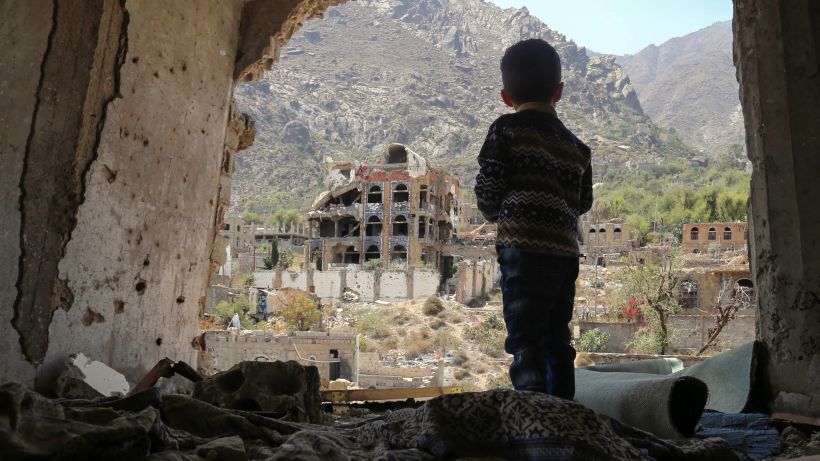 TOPSHOT - A photo taken on March 18, 2018, shows a Yemeni child looking out at buildings that were damaged in an air strike in the southern Yemeni city of Taez. / AFP PHOTO / Ahmad AL-BASHA        (Photo credit should read AHMAD AL-BASHA/AFP/Getty Images)