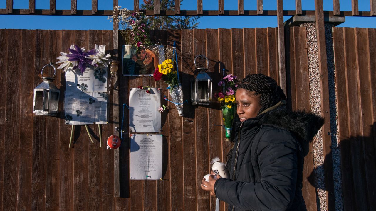 Tilisha Goupall tends a memorial to her younger brother, Jermaine Goupall, at the location where he was stabbed to death in south London in August 2017.