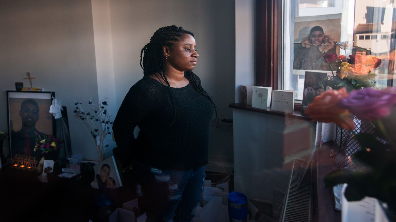 Goupall is seen through the window of her family's front room in Thornton Heath, south London. The room has become a shrine dedicated to honoring the life of her brother, Jermaine.
