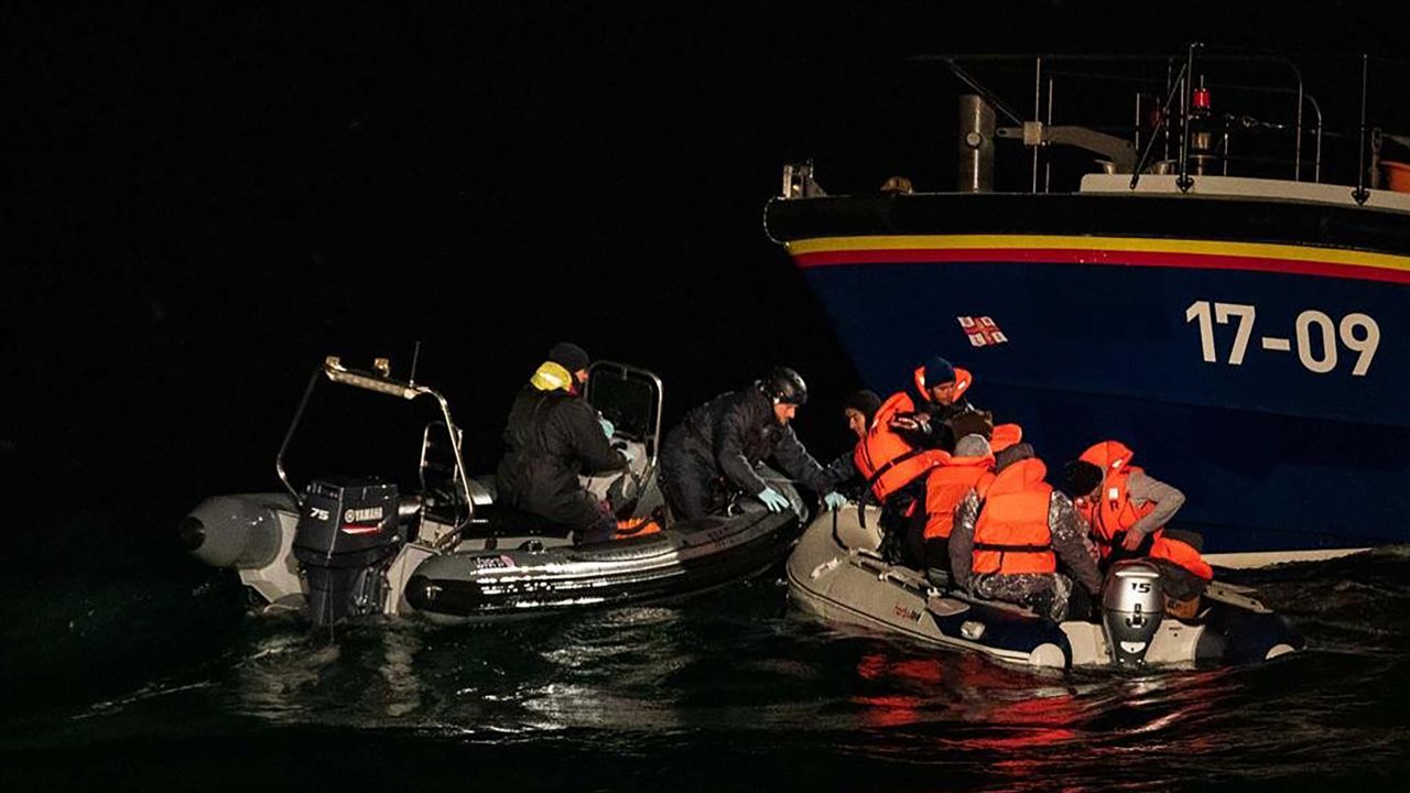 Iranian migrants traveling in a dinghy are picked up by a British lifeboat and French Maritime Police.
