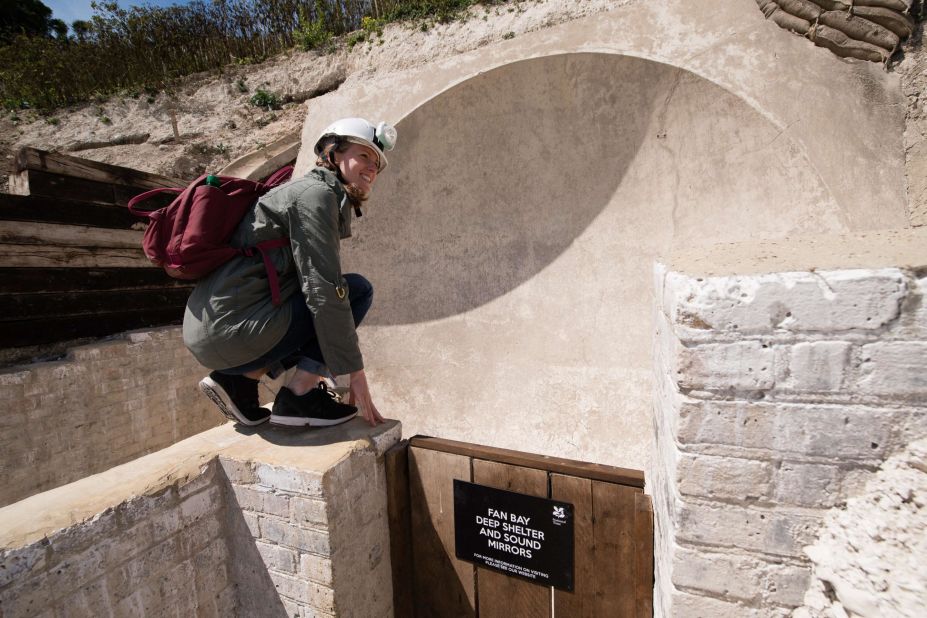 A woman poses by a First World War "sound mirror" listening device at the Fan Bay Deep Shelter within the cliffs overlooking Dover, England. The National Trust rediscovered the tunnels after purchasing the land in 2012 and after a major restoration project, the tunnels are now open to the public. 
