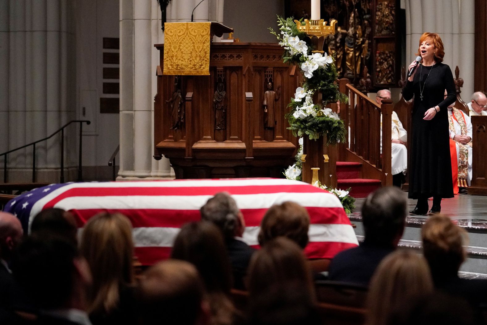 Reba McEntire sings "The Lord's Prayer" during Bush's funeral service in Houston.