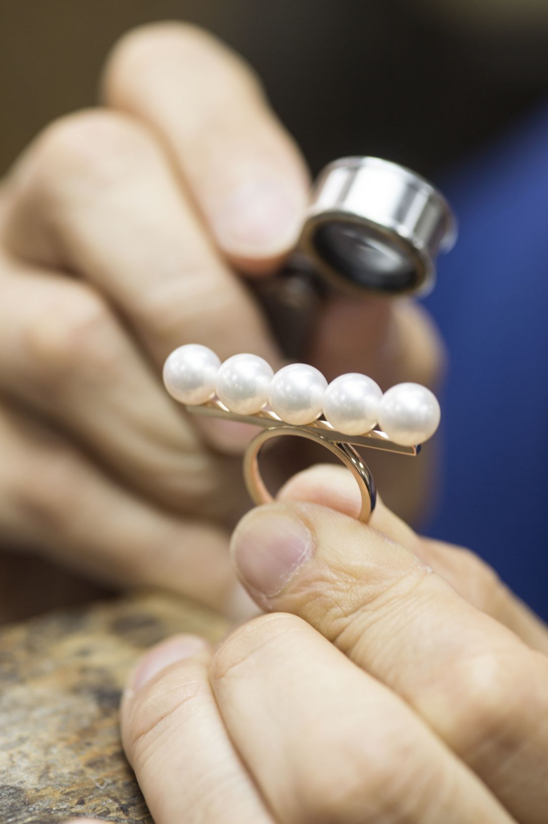 A ring, designed by jewelry house Tasaki, featuring five seemingly identical Akoya pearls.