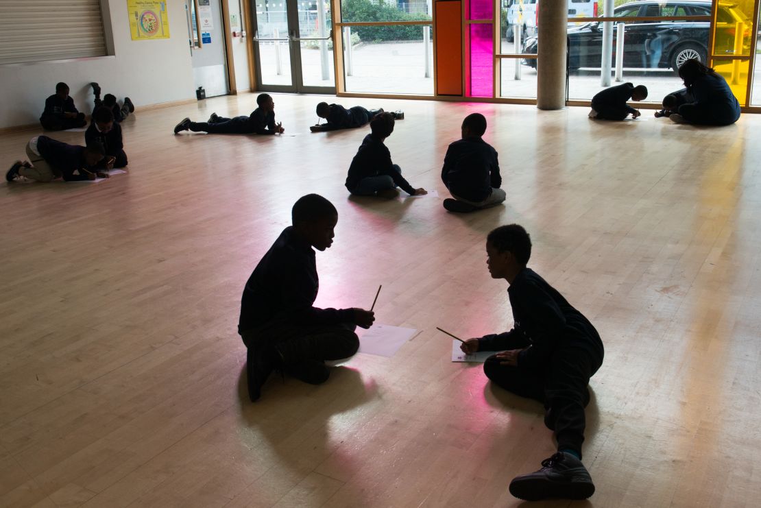 Boys participating in the Manhood Academy program work in pairs to list things that they are good at doing.