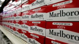 FILE- This June 14, 2018, file photo shows cartons of Marlboro cigarettes on the shelves at JR outlet in Burlington, N.C. Curiosity from one the world's largest tobacco companies about the marijuana business sent shares of a Canadian cannabis company higher at the opening bell Tuesday, Dec. 4. Cronos Group confirmed talks late Monday with Marlboro maker Altria about a possible investment. (AP Photo/Gerry Broome, File)