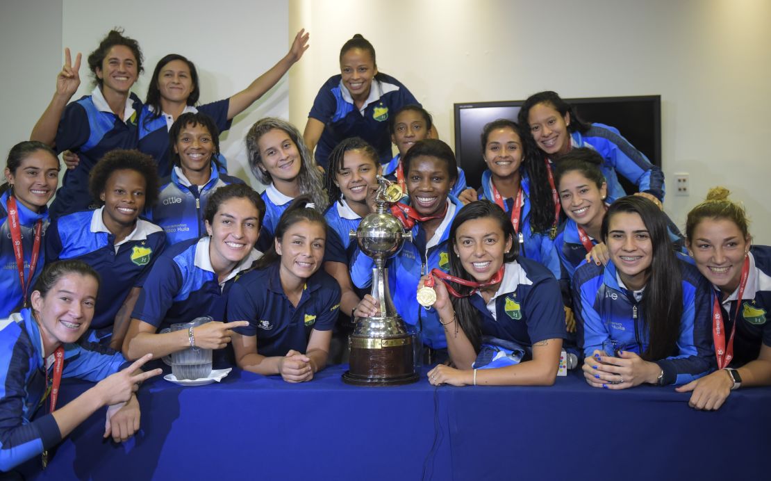 Colombia's Atletico Huila Femenino players pose with the Copa Libertadores trophy at a press conference in Bogota.